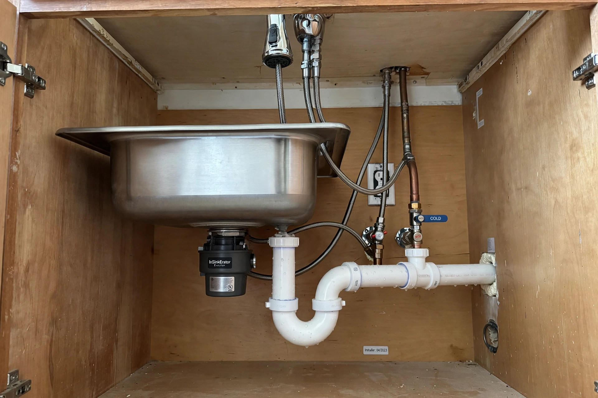 Kitchen sink plumbing with supply lines and drain installed in Vero Beach FL